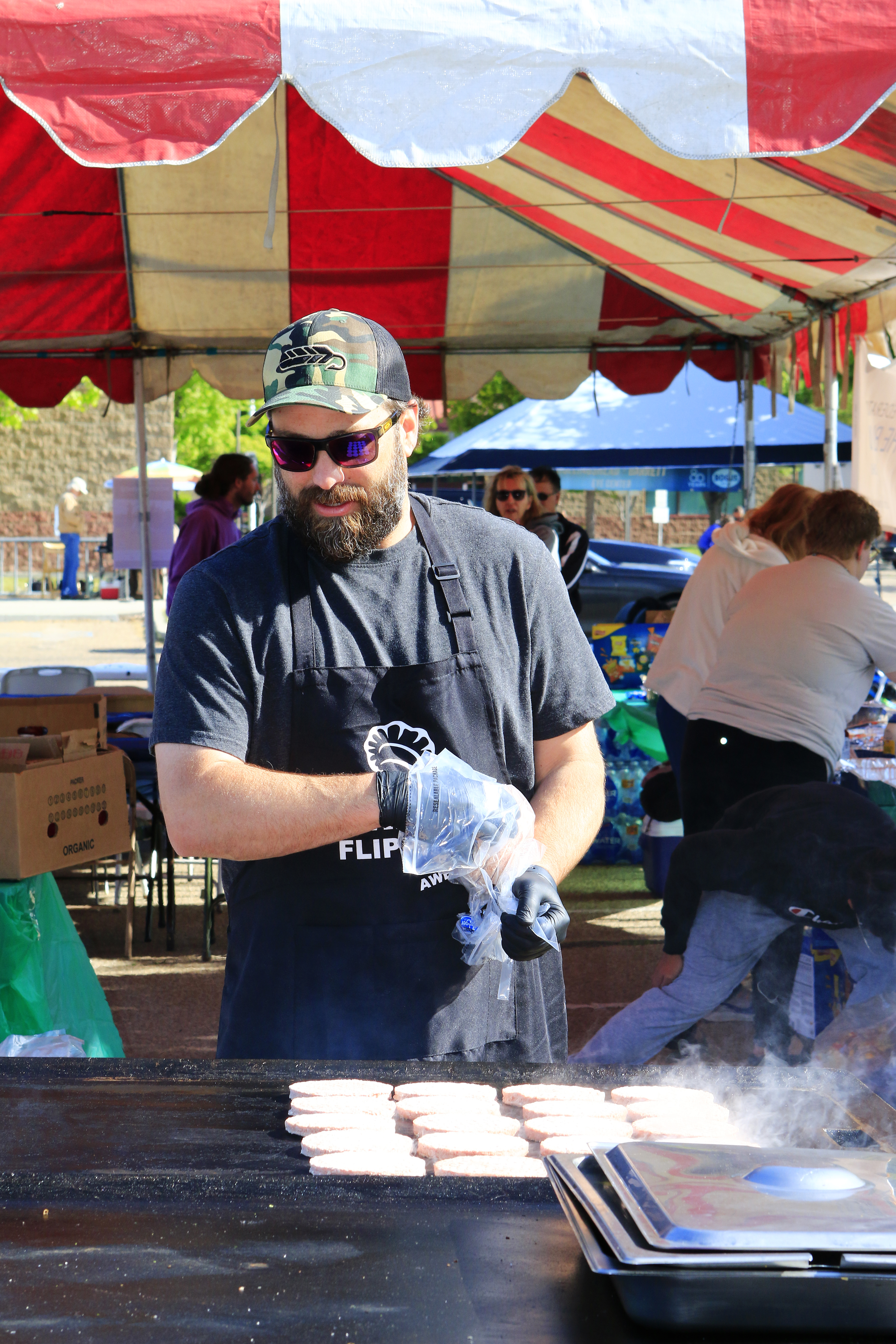 Volunteer grilling food.