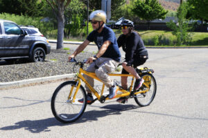 Tandem bike riders coming back from their ride.